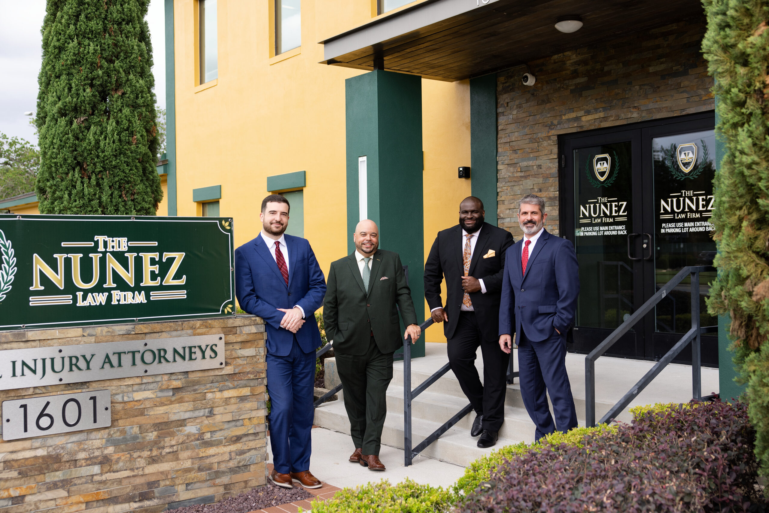 The Nunez Law Firm injury attorneys standing outside the firm's office